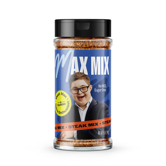 Shaker of Max Mix Steak Mix. The label shows a picture of founder Max on a dark blue textured background, with a yellow medal that reads "Meet Max: Spice Enthusiast"