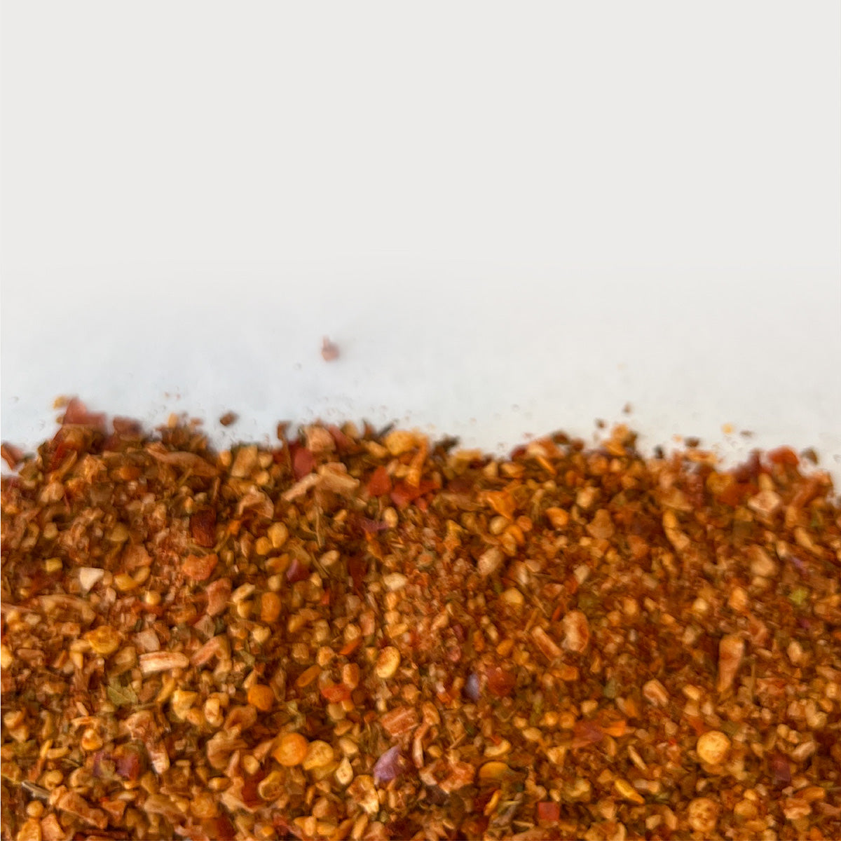 Close-up picture of Steak Mix, scattered over a white background.